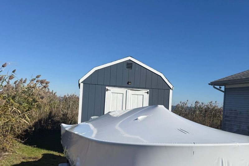 Wrapped and tucked in beside the shed for the season.