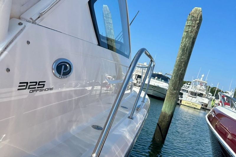 Pursuit 325 Offshore docked at a marina, kept on a recurring wash plan