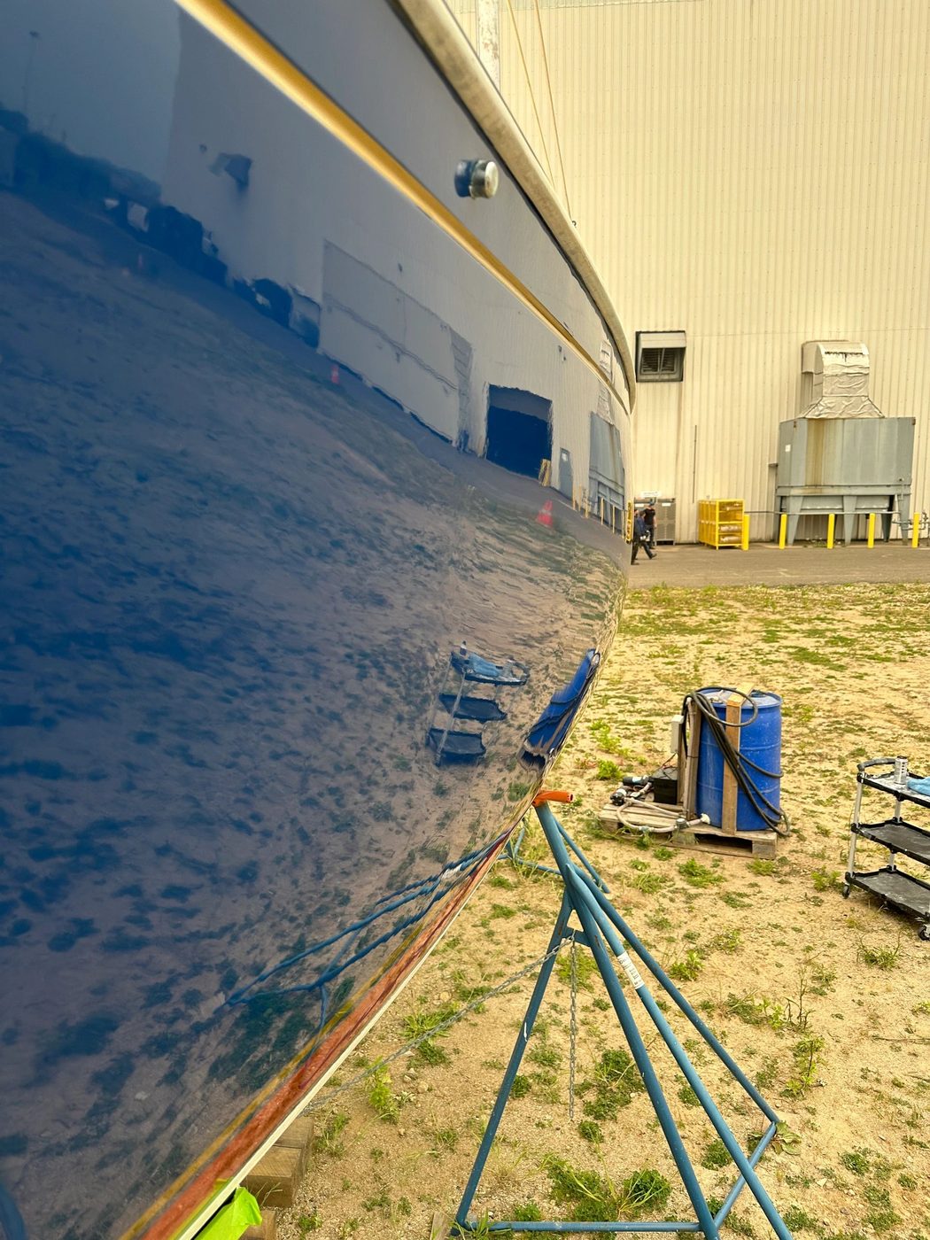 Reflection on a polished blue boat hull after a buff and shine
