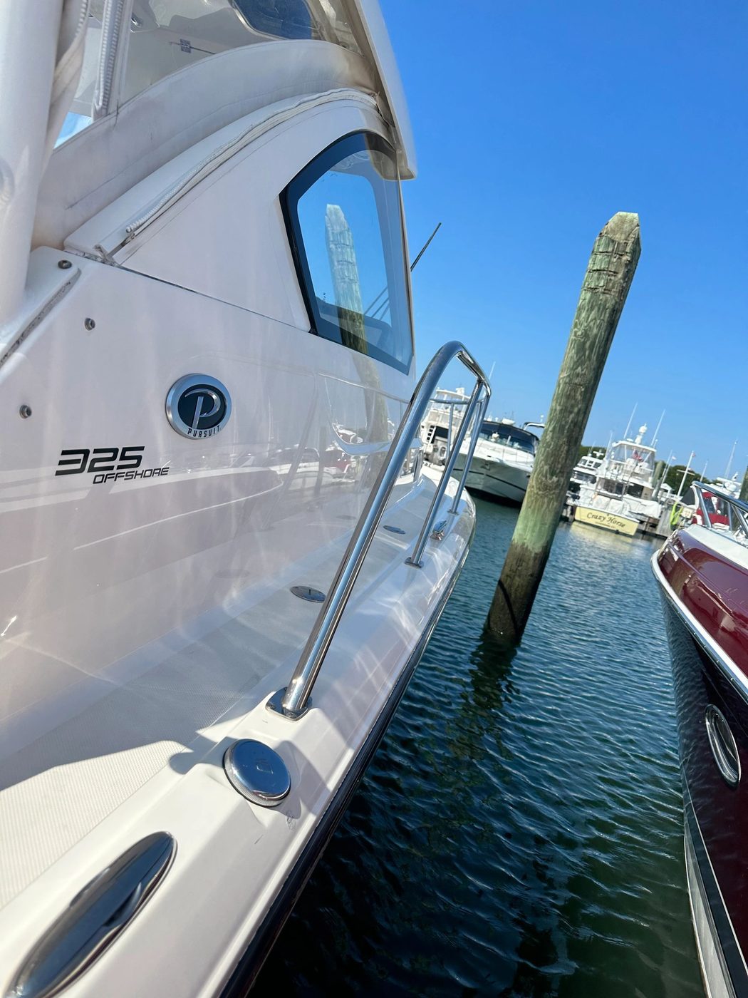 Pursuit 325 Offshore docked at a marina, kept on a recurring wash plan